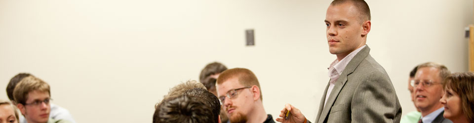 man giving speech to students